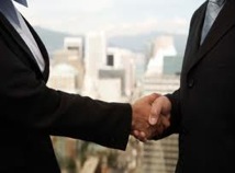 picture of two men in suits shaking hands