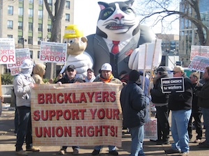 Bricklayers Union with Fat Cat balloon - the Fat Cat has 'Koch Brothers' on his lapel and is squeezing a little guy with 'Wisconsin Workers' on his hard hat.