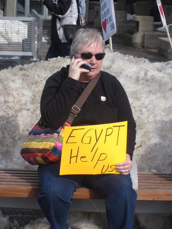 A protester waits on a snowbank for help from Egypt.