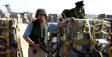 Soldiers guarding pallets of money in Iraq