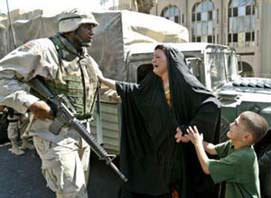 Iraqi woman and child with U.S. soldier (Navy photo)
