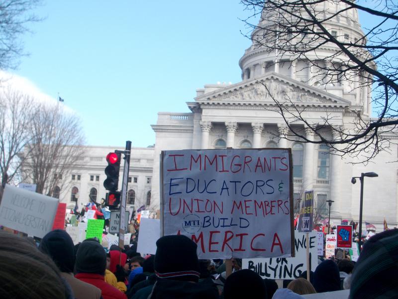 Protest sign: Immigrants, educators & union members build America