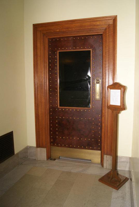 Door to the Assembly gallery with black plastic over the window (Source: Leslie Peterson)